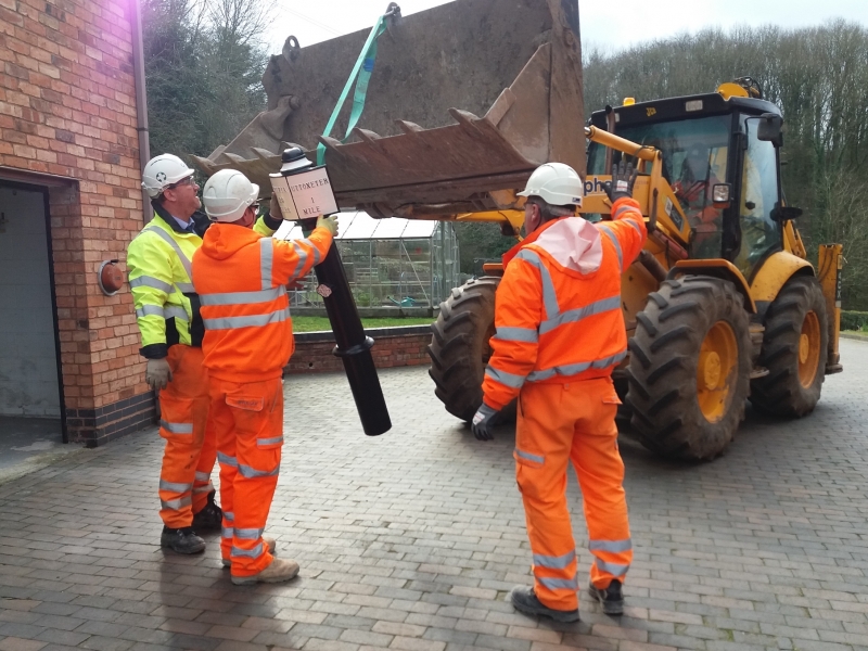 The team from Tarmac collect milepost 29 before installation